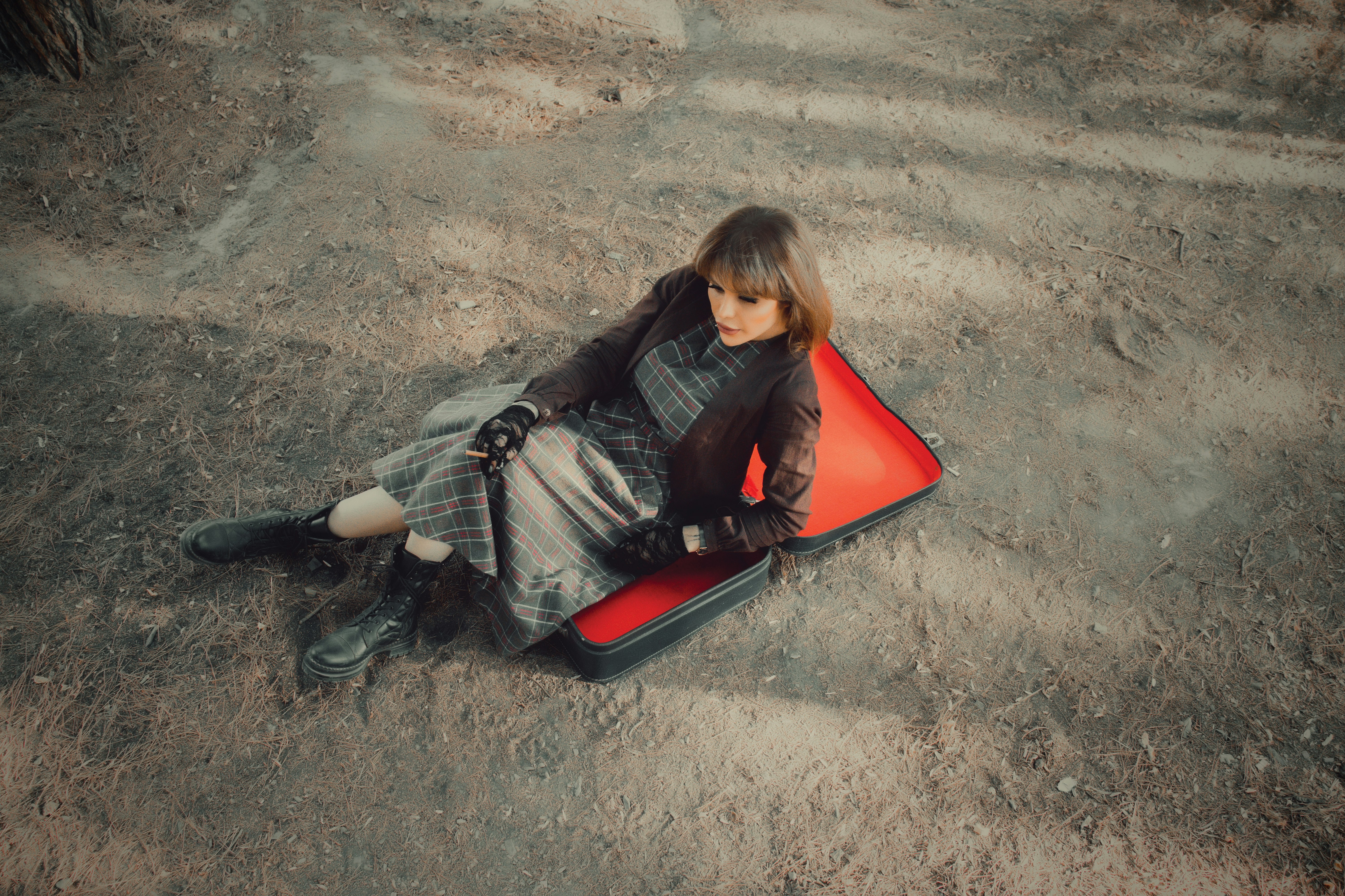 woman in black jacket sitting on red plastic chair